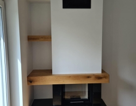 Nasze realizacje - Nowoczesne NR-N-265 - Nowoczesny kominek wykończony czarnym granitem z wkładem Hajduk z szybą przesuwaną do góry zapobiegającą zadymieniu.